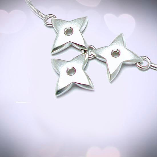 Aniara four pointed stars or flowers silver jewellery collection rings earrings pendants necklaces cufflinks chains by Annika Rutlin high quality unique and unusual solid sterling silver designer jewellery handmade in the UK