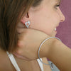 Model wears Annika Rutlin heart stud earring and heart bangle solid silver