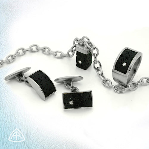 An unusual collection of diamond set black lava silver jewelry by award winning Scandinavian designer Annika Rutlin. Black lava ring, pendant and cufflinks each flush set with sparkling white diamonds. A great choice for mens jewellery gifts