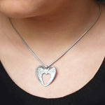 Annika Rutlin heart shaped angel wings pendant solid silver on model