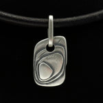 alternative dog tag jewellery with layered texture made from solid silver on leather