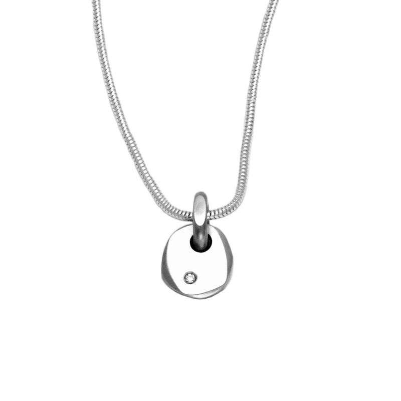 A delicate silver pebble pendant with a high quality diamond by jewellery designer Annika Rutlin