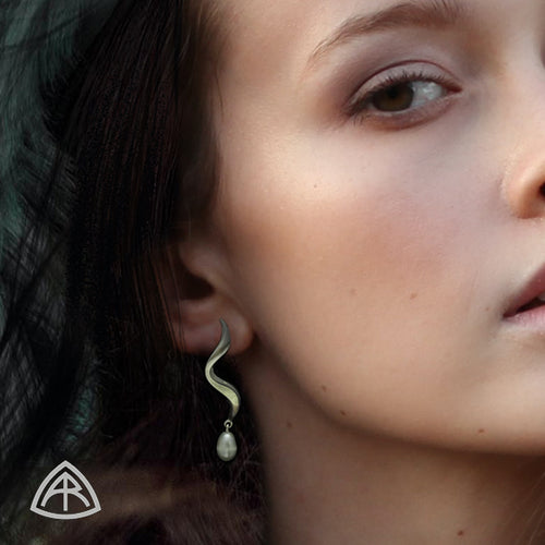 Annika Rutlin Luna white pearl silver wave earrings on model