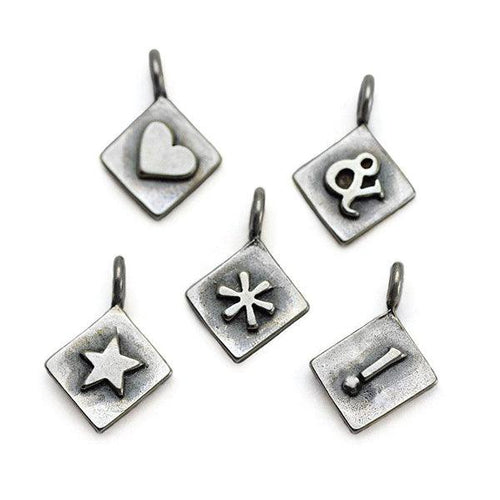 Sterling silver symbol charms by award winning jeweller Annika Rutlin
