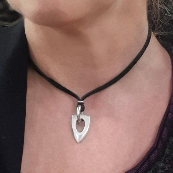 Idun large pointed silver pendant on suede on model neck