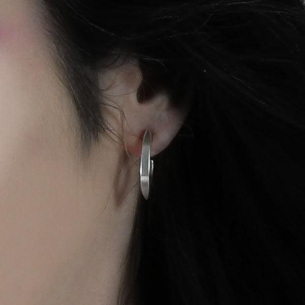 Annika Rutlin sterling silver solid 3/4 stud hoop earrings on the ear of female model