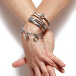 Annika Rutlin stacked bangles and bracelets in sterling silver from the Goddess Tara silver jewellery collection